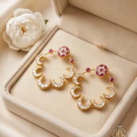 Pair of designer Kundan baliyan with zircon work displayed in a cream jewellery box