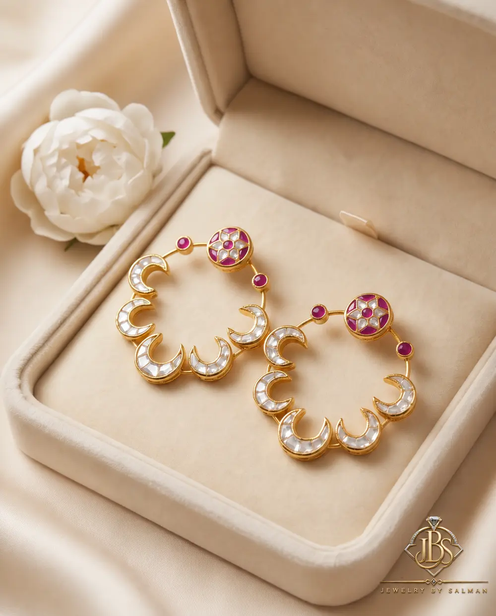 Pair of designer Kundan baliyan with zircon work displayed in a cream jewellery box