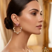 Model wearing a designer Kundan bali earring with crescent detailing and zircon work