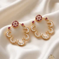 Pair of designer Kundan baliyan with crescent detailing, magenta accents and zircon work on cream satin